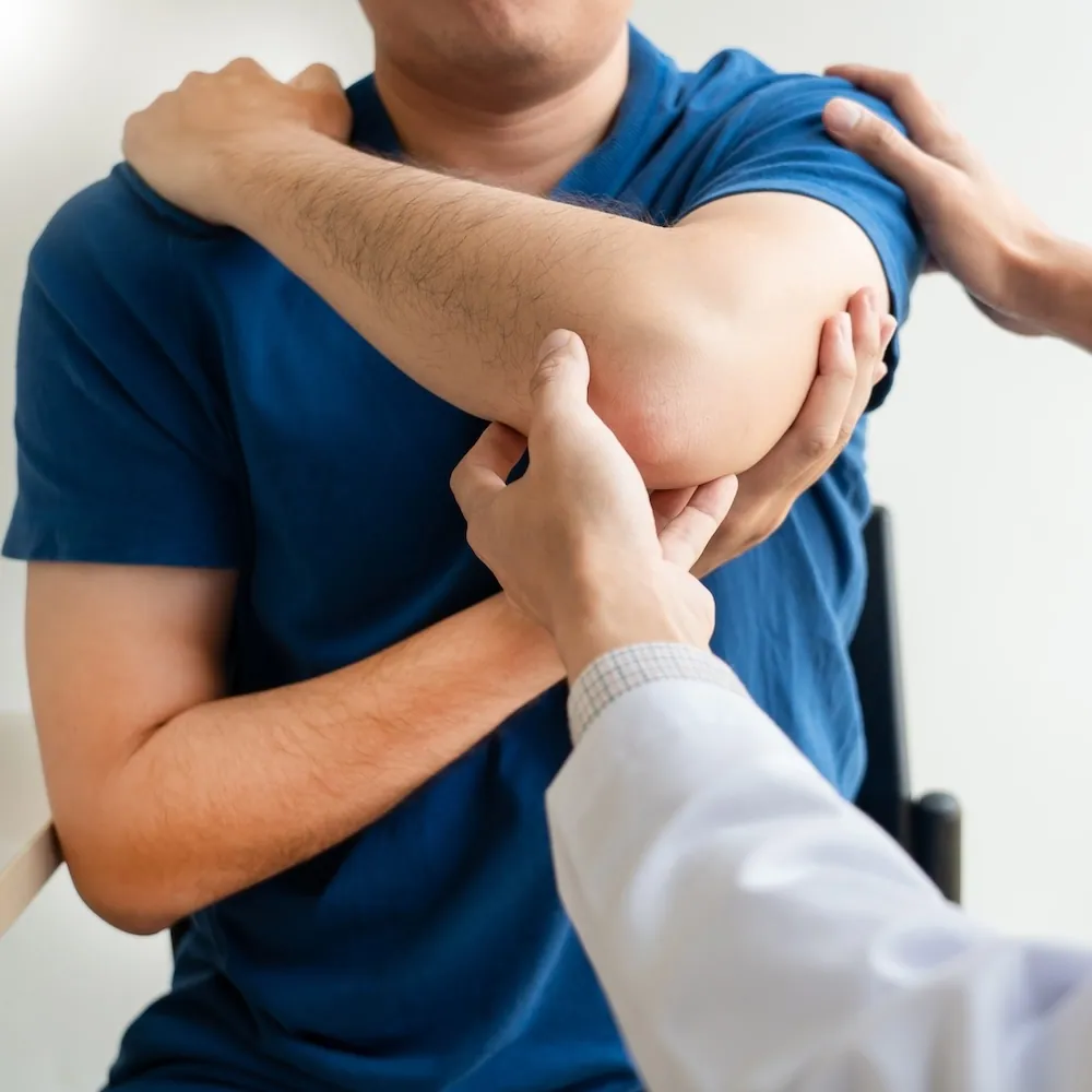 Doctor examining a patient’s elbow