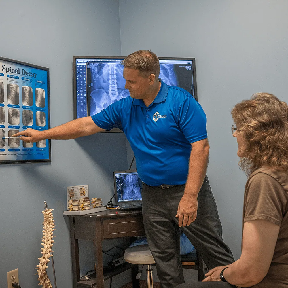 Chiropractor explaining spinal health to a patient