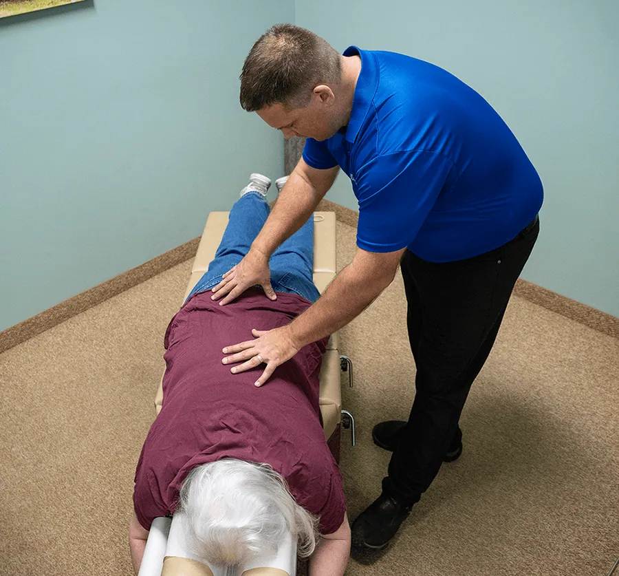 Chiropractor adjusting a patient’s lower back at Catalyst Chiropractic & Rehab