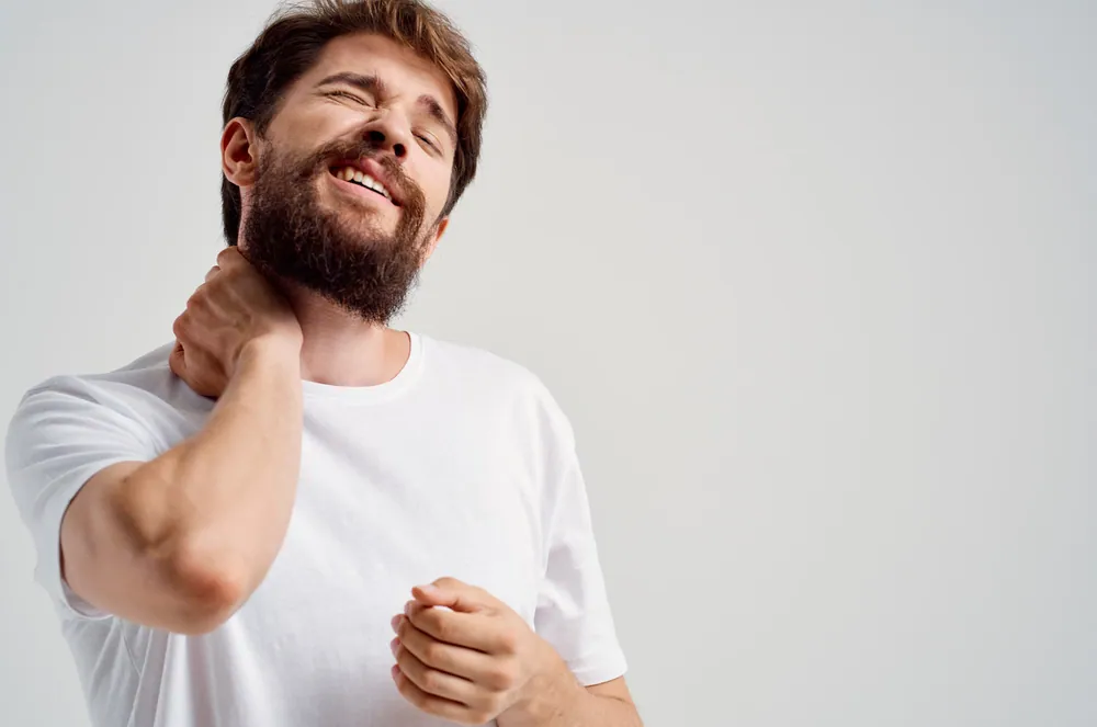 bearded man having a neck pain