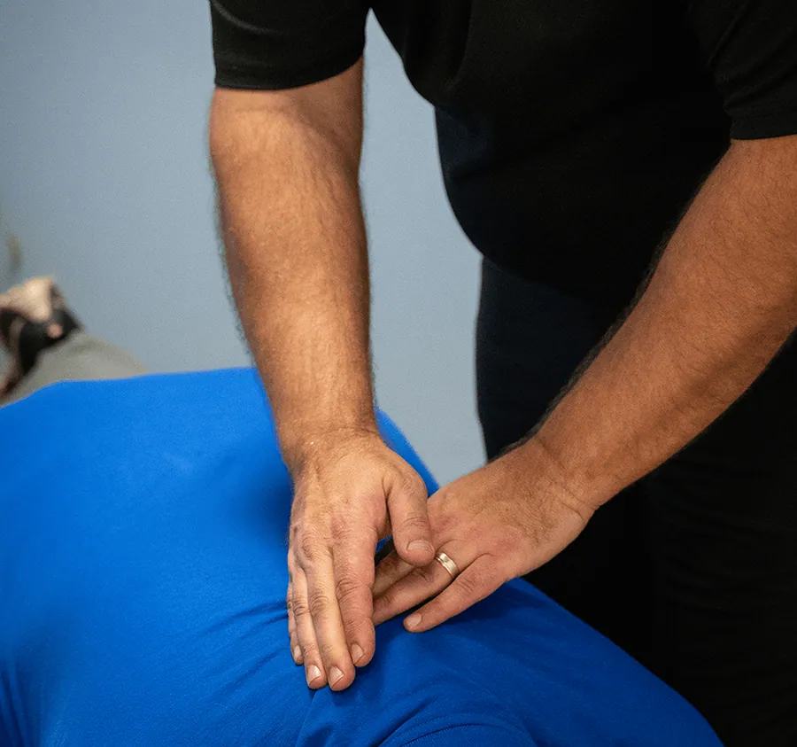 Chiropractor’s hands during a spinal adjustment