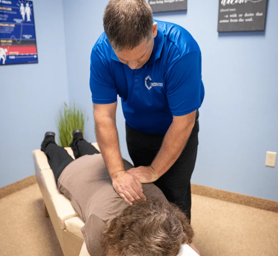 Chiropractor adjusting a patient’s upper back